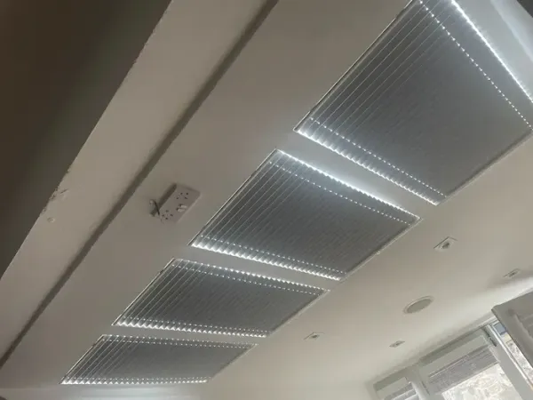 Ceiling-mounted pleated blinds in a modern room