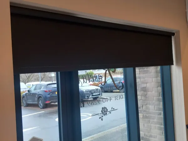 Dark roller blind on a commercial shopfront window