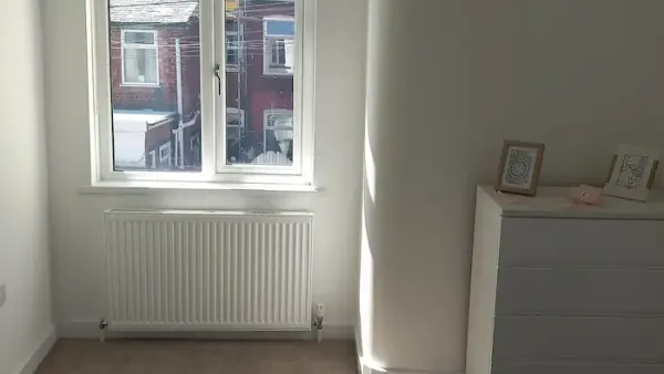 White blackout roller blind fitted in an Edinburgh bedroom window
