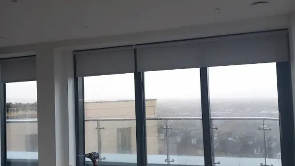 Made-to-measure roller blinds across a wide run of panoramic windows