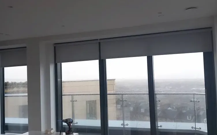 Made-to-measure roller blinds across a wide run of panoramic windows