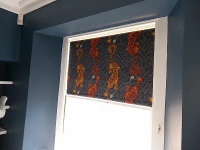 Bold tiger print roller blind on a blue wall
